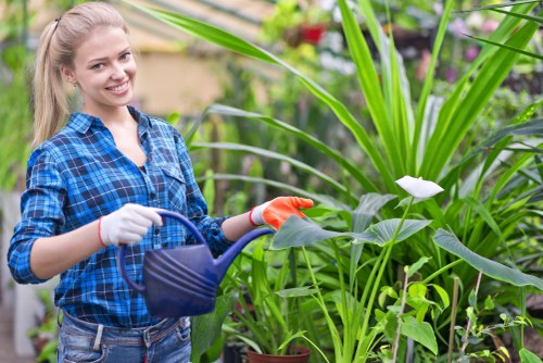 Supervisor reviewing job records on a clipboard in a garden