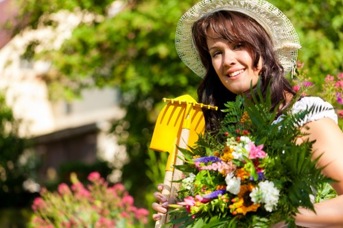 Gardener wearing PPE and high-visibility clothing while working
